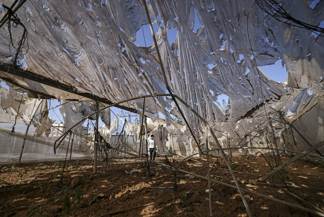A Palestinian man inspects damage caused by an early morning Israeli air strike in the Maghazi refugee camp in the central Gaza Strip, on November 4, 2022. Israeli fighter jets early today targeted a rocket manufacturing site in the Gaza Strip, in response to rockets fired towards Israel, the army said. (Photo by Mahmud Hams/AFP Photo)