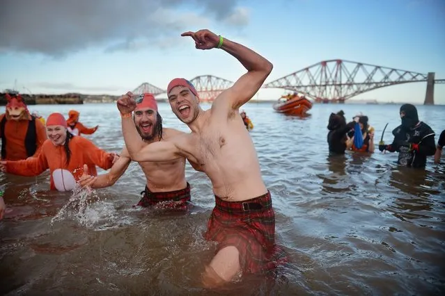 Over 1,000 New Year swimmers, many in costume, braved freezing conditions in the River Forth in front of the Forth Rail Bridge during the annual Loony Dook Swim on January 1, 2013 in South Queensferry, Scotland. Thousands of people gathered last night to see in the New Year at Hogmanay celebrations in towns and cities across Scotland.  (Photo by Jeff J. Mitchell)