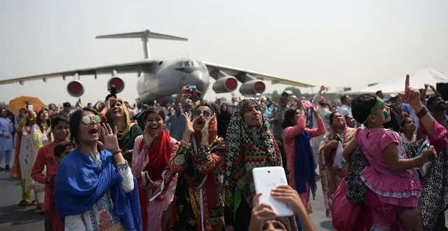 Pakistani forces families and students watch the fly past by a F-16 fighter during celebrations to mark Defence Day at the Nur Khan military airbase in Islamabad on September 6, 2016. Pakistan on September 6 celebrated the 51st anniversary of its second war with arch-rival India weeks after the two nuclear powers faced off in some of their deadliest skirmishes in over a decade. The major fighting of the war took place between August and September 1965 with both sides claiming victory after it ended in stalemate following the intervention of the United States and Soviet Union. (Photo by Aamir Qureshi/AFP Photo)