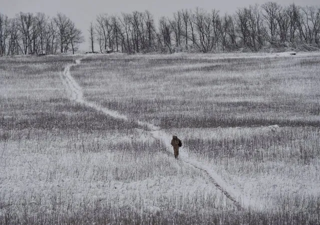 A Ukrainian serviceman is seen as he walks near the government-held village of Travneve, Ukraine, November 23, 2017. (Photo by Oleksandr Klymenko/Reuters)