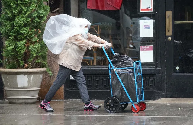 A woman braves the rain and wind in NYC on August 4, 2020, after Tropical Storm Isaias traveled up the Eastern Seaboard. (Photo by Robert Miller/The New York Post)