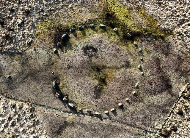 An image taken with a drone shows the Bronze Age Fernworthy Stone Circle in the landscape of Dartmoor, Britain, 25 March 2025. The South West Peatland Partnership is working to restore degraded peatland across large areas of the UK. Since Roman times, peat has been used as fuel and for fertiliser in agricultural use. In Dartmoor, which is common land, people were able to cut peat on a large scale by draining the land and digging long gullies, which reduced the water table and damaged the remaining peat. The practice was industrialised until the 1950s. Currently, the UK government has set targets to phase out peat use in horticulture by 2030. Peat bogs are environmentally vital as they store huge amounts of carbon, twice as much as the world's forests. The degradation of peatland leads to carbon being released into the atmosphere, which adds to global warming. Justine Reed from South West Water notes: “In the UK, the health of peatlands acts like a canary in a coal mine. When this ecosystem becomes damaged, then it means a catastrophic environmental disaster will follow. Currently we are on the edge but can’t afford to let things get worse”. (Photo by Neil Hall/EPA)
