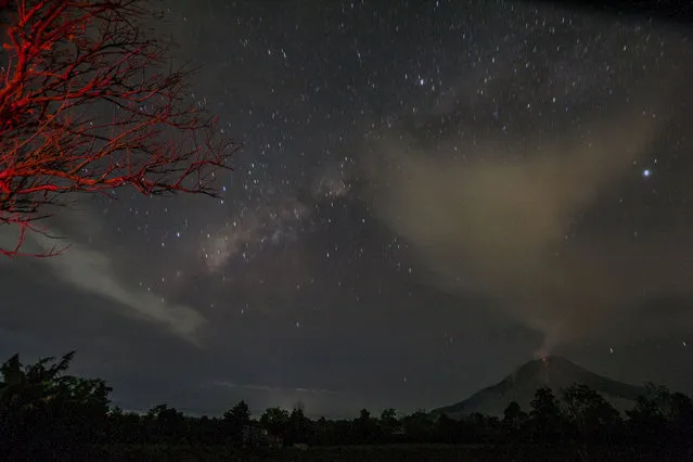 The Milky Way is visible as Mount Sinabung erupts at Kampung Dalam village in Karo, Indonesia on July 9, 2016. (Photo Barcroft Images/Xinhua)