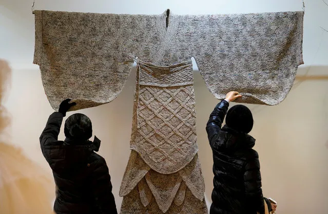 Visitors check the details of a creation of Han-dynasty (202 BC-AD 220) costume by designer Wang Lei, which is made of old newspapers, at the 3rd Beijing International in Style Expo in Beijing, China January 15, 2018. (Photo by Jason Lee/Reuters)