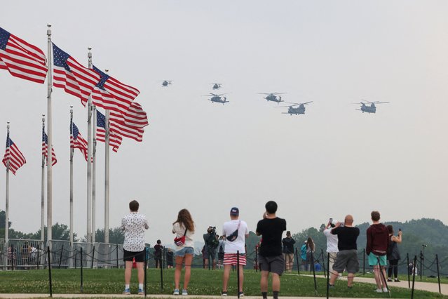 Spectators observe as helicopters, including CH-47 Chinnok aircraft, are flown during the parade in Washington on June 14, 2025. (Photo by Evelyn Hockstein/Reuters)