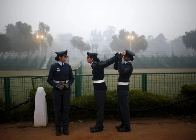 An Indian Air Force soldier (R) stretches the arms of her colleague during the rehearsal for the Republic Day parade on a cold and foggy winter morning in New Delhi, India, in this December 30, 2014 file photo. India is opening the way for women pilots to fly fighter jets in combat, its air force chief said, as one of the world's biggest military forces shakes off its reluctance to give greater responsibilities to women. (Photo by Ahmad Masood/Reuters)