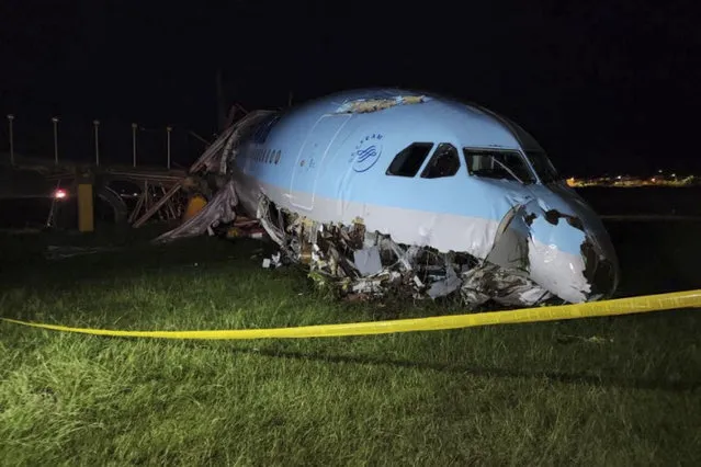 In this handout photo provided by the Civil Aviation Authority of the Philippines, a damaged portion of the Korean Air Lines Co. plane lies after it overshot the runway at the Mactan Cebu International Airport in Cebu, central Philippines, on Monday, October 24, 2022. A Korean Air Lines Co. plane carrying 173 passengers and crew members overshot a runway while landing in bad weather in the central Philippines late Sunday and authorities said all those on board were safe. The airport is temporarily closed due to the stalled aircraft. (Photo by Civil Aviation Authority of the Philippines via AP Photo)