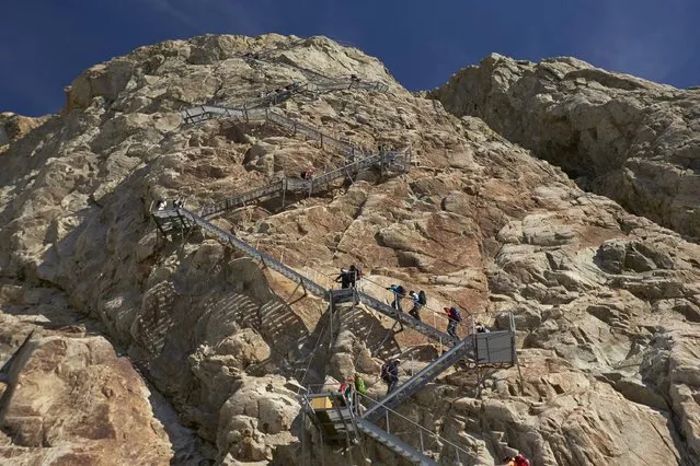 Hikers climb the 460 steps up to the Konkordia Hut on the Aletsch Glacier, Switzerland, August 28, 2015. (Photo by Denis Balibouse/Reuters)