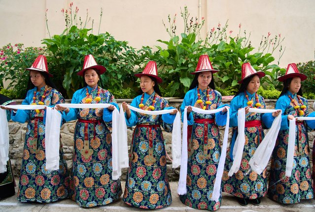 Exiled Tibetan women in traditional attire carry ceremonial scarf as part of the rituals during the 90th birthday celebration of spiritual leader the Dalai Lama at the Tibetan Camp in Kathmandu, Nepal, Sunday, July 6, 2025. (Photo by Niranjan Shrestha/AP Photo)