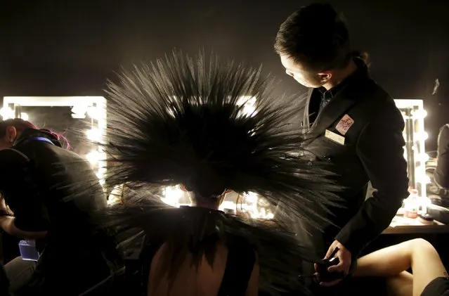 A model has make-up applied backstage before a colorful cosmetic fashion trend collection by Chinese designer Mao Geping at China Fashion Week S/S 2016, in Beijing, China, October 26, 2015. (Photo by Jason Lee/Reuters)