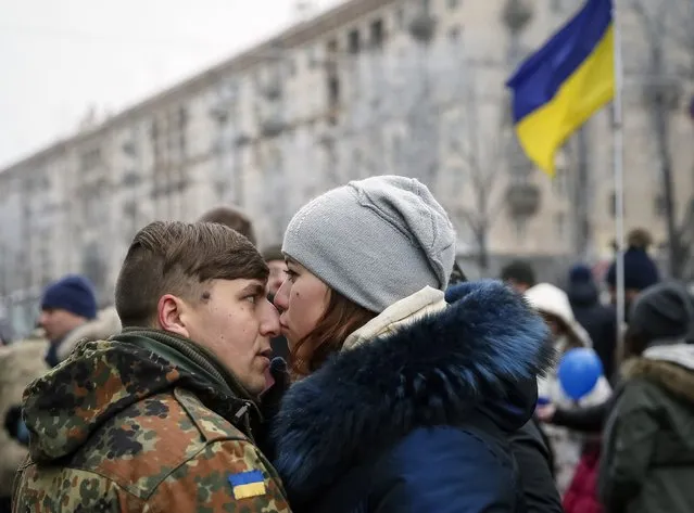 A woman kisses her boyfriend from “Kiev 12” military defence battalion before a welcoming ceremony in central Ukrainian capital Kiev December 6, 2014. (Photo by Gleb Garanich/Reuters)