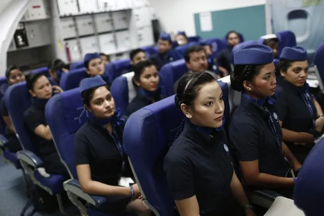 Prospective flight attendants listen to their instructor during a training session at Indigo Airlines' Ifly training centre in Gurgaon on the outskirts of New Delhi November 18, 2014. (Photo by Adnan Abidi/Reuters)
