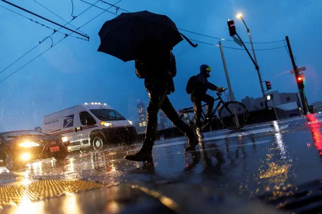 A local resident crosses a street as rainstorms hit the city of San Francisco, in California, U.S., January 4, 2023. (Photo by Carlos Barria/Reuters)