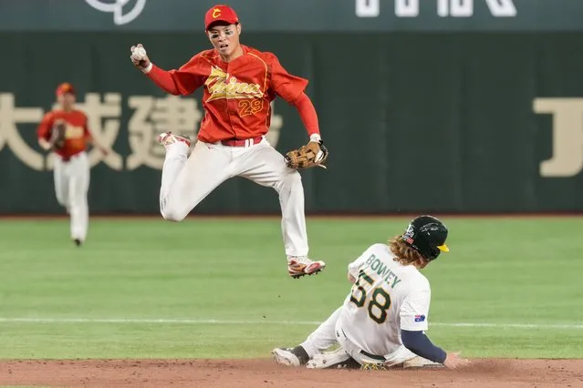Luo Jinjun of China catches the ball as Jake Bowey of Australia slides into second base during their Pool B game at the World Baseball Classic at the Tokyo Dome, Japan, Saturday, March 11, 2023. (Photo by Eugene Hoshiko/AP Photo)