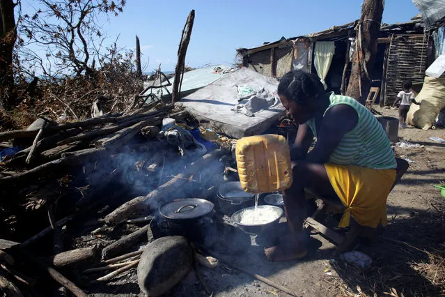 A woman adds water as she is cooking after Hurricane Matthew in Les Anglais, Haiti, October 13, 2016. (Photo by Andres Martinez Casares/Reuters)