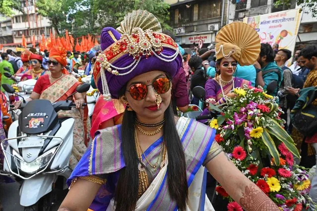 Women dressed in traditional attire and finery take part in a procession celebrating “Gudi Padwa” or the Maharashtrian New Year, in Mumbai on March 22, 2023. (Photo by Indranil Mukherjee/AFP Photo)
