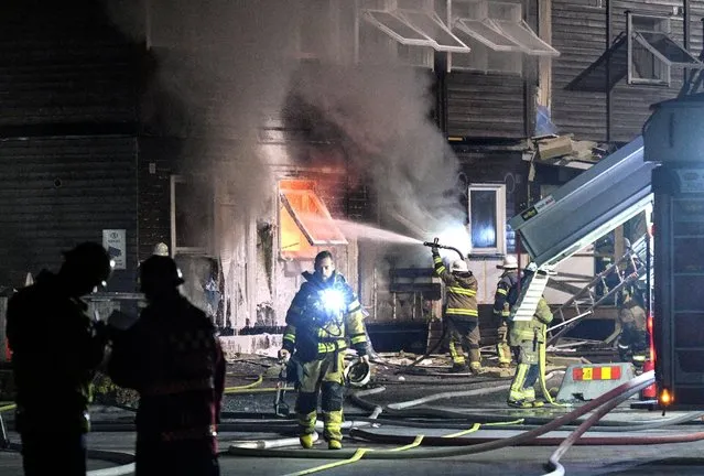 Firefighters extinguish a fire that broke out at a refugee accommodation in Fagersjo, south of Stockholm, Sweden on the night of October 16, 2016. (Photo by Johan Nilsson/Reuters/TT News Agency)