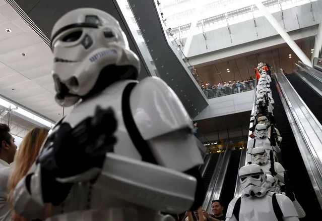 Stormtroopers take the escalator as they march around Singapore's Changi Airport November 12, 2015. (Photo by Edgar Su/Reuters)