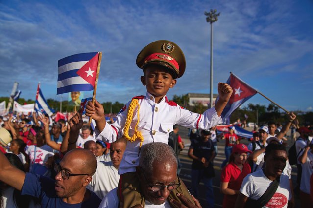 A boy dressed in a military uniform is carried on his grandfather's shoulders in the annual May Day parade at Revolution Square in Havana, Thursday, May 1, 2025. (Photo by Ramon Espinosa/AP Photo)