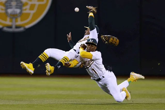 Oakland Athletics second baseman Tony Kemp, left, and center fielder Esteury Ruiz dive unsuccessfully for an RBI double by Cleveland Guardians' Jose Ramirez during the fifth inning of a baseball game in Oakland, Calif., Tuesday, April 4, 2023. (Photo by Jed Jacobsohn/AP Photo)