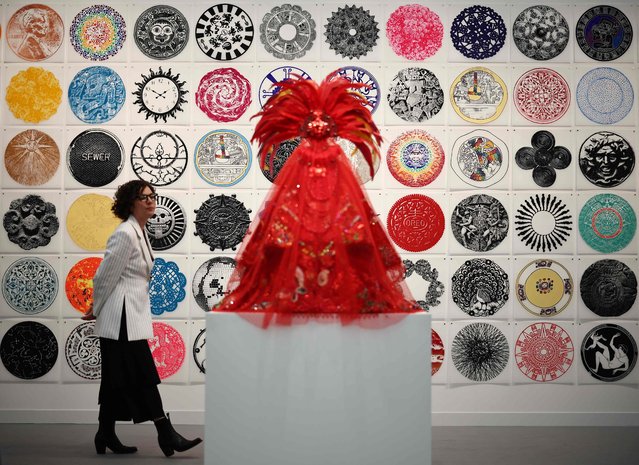 Guests look at the work entitled “Circumference” by Rene Trevino at the Erin Cluley Gallery at the Frieze London 2025 exhibition in London on October 15, 2025. (Photo by Henry Nicholls/AFP Photo)