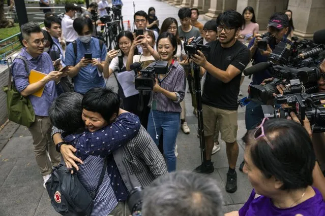 Convicted journalist Bao Choy reacts with supporters after being cleared by top Hong Kong court in Hong Kong, Monday, June 5, 2023. Choy won an appeal quashing her conviction related to work on her investigative documentary Monday in a rare court ruling upholding media freedom in the territory. (Photo by Louise Delmotte/AP Photo)