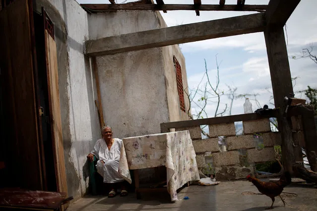Case Jean, 92, poses for a photograph in her destroyed house after Hurricane Matthew hit Jeremie, Haiti, October 17, 2016. Jean is very old and does not speak, a relative said. (Photo by Carlos Garcia Rawlins/Reuters)