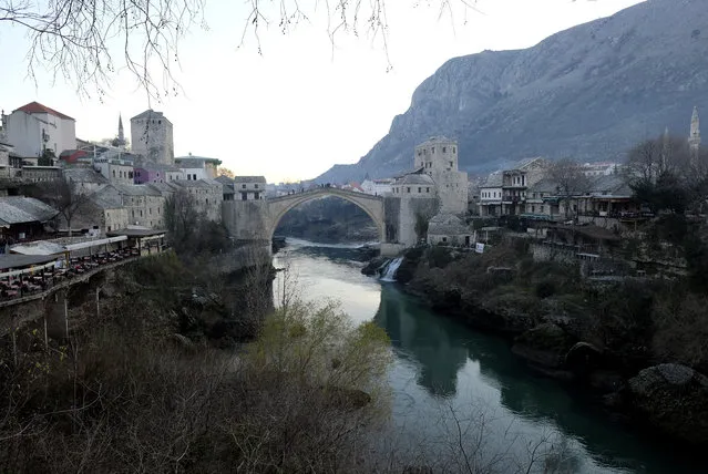 The Old Bridge in Mostar, one of Bosnia's best known landmarks, Bosnia, in Mostar, Bosnia, Sunday, December 20, 2020. Divided between Muslim Bosniaks and Catholic Croats, who fought fiercely for control over the city during the 1990s conflict, Mostar has not held a local poll since 2008, when Bosnia's constitutional court declared its election rules to be discriminatory and ordered that they be changed. (Photo by Kemal Softic/AP Photo)