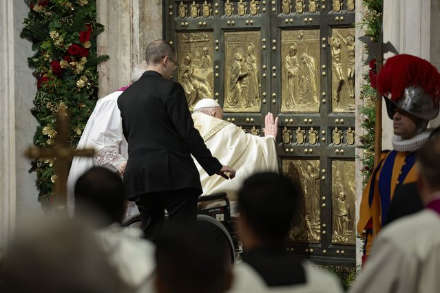 Pope Francis opens the Holy Door to mark the opening of the 2025 Catholic Holy Year, or Jubilee, in St. Peter's Basilica, at the Vatican, December 24, 2024. (Photo by Remo Casilli/Pool Photo via AP Photo)