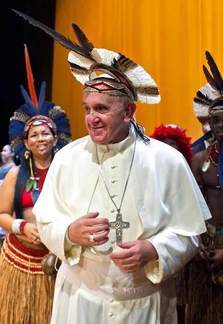 Pope Francis wears an indigenous headdress given to him by Ubirai Matos from the Pataxo tribe after the pontiff spoke at Rio's Municipal Theater. (Photo by L'Osservatore Romano)