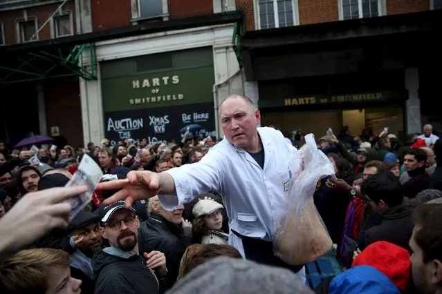 Butchers sell their remaining produce of the year at discounted prices during the traditional Christmas Eve auction at Smithfield's market in London December 24, 2015. (Photo by Neil Hall/Reuters)