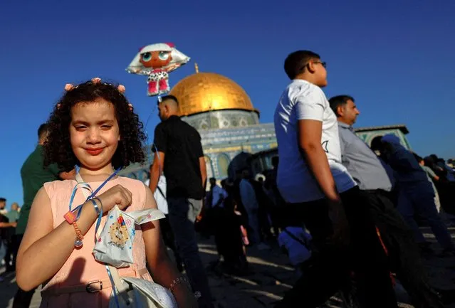 A girl poses for a picture as Palestinians celebrate the first day of the Muslim holiday of Eid al-Adha in the Al-Aqsa compound, also known to Jews as the Temple Mount, in Jerusalem's Old City on June 28, 2023. (Photo by Ammar Awad/Reuters)