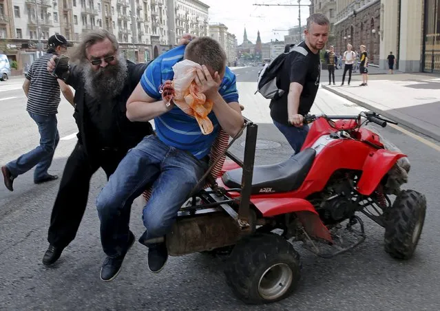 Anti-gay protesters attack a gay rights activist during an LGBT community rally in central Moscow, Russia, May 30, 2015. (Photo by Maxim Shemetov/Reuters)