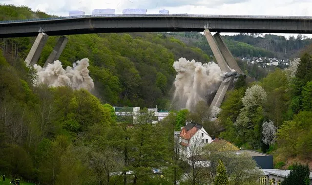 Explosive charges demolish the Rahmede valley bridge along the A45 highway on May 7, 2023 near Luedenscheid, Germany. The demolition is part of construction to expand the A45 highway to six lanes. Highway expansion and construction have become a contentious topic for Germany's three-party governing federal coalition, with the pro-business FDP pushing highway projects forward and the Greens advocating instead for more investment into Germany's railway network. (Photo by Sascha Schuermann/Getty Images)