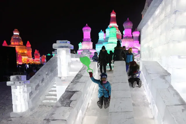 Visitors enjoy riding on ice slides of large ice sculptures at Harbin ice and snow world during the opening ceremony of the 32nd Harbin International Ice and Snow Festival in Harbin city, China's northern Heilongjiang province, 05 January 2016. The festival runs from 05 January to 05 February. (Photo by Wu Hong/EPA)