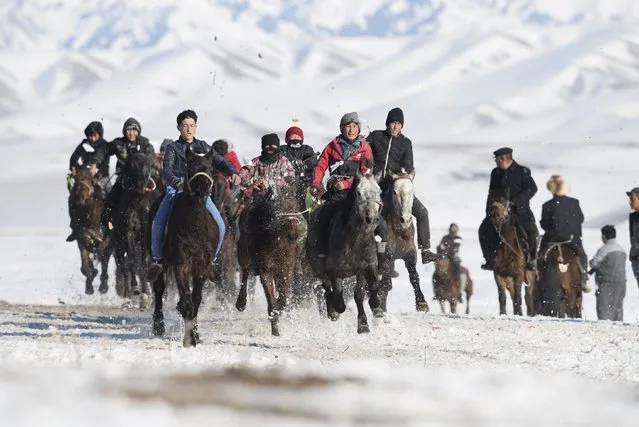 Herders ride horses during a race at a winter festival in Yining, Xinjiang Uighur Autonomous Region, China, January 10, 2016. The Kazakh festival included games such as Buzkashi, horse racing, wrestling and Kyz Kuu (catch the girl), according to local media. (Photo by Reuters/China Daily)