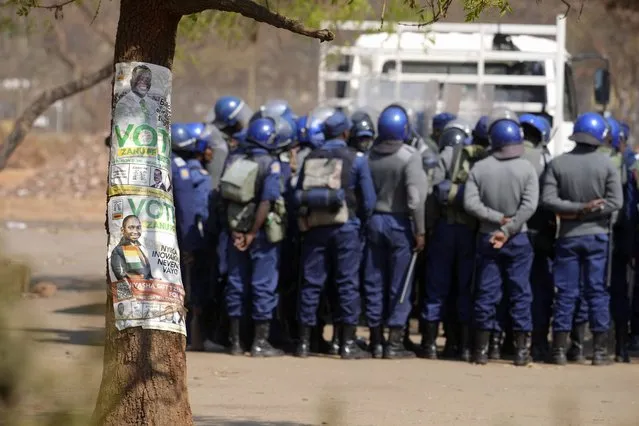 Armed riot police prepare to be deployed on the streets of Harare, Zimbabwe, Friday, August 25, 2023. Hordes of police officers armed with batons, teargas canisters and some with guns were seen next to the result centre as Zimbabweans anxiously waited for the outcome of general elections after polls closed on Thursday and authorities tightened security around the results centre. (Photo by Tsvangirayi Mukwazhi/AP Photo)