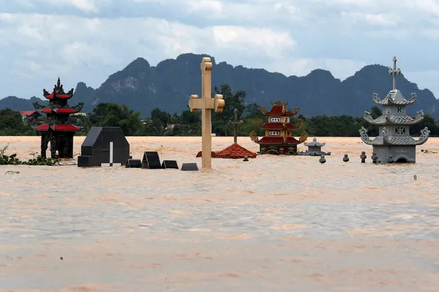 Submerged tombs are seen at a flooded village after heavy rainfall caused by tropical storm Son Tinh in Ninh Binh province, Vietnam, July 22, 2018. (Photo by Reuters/Kham)