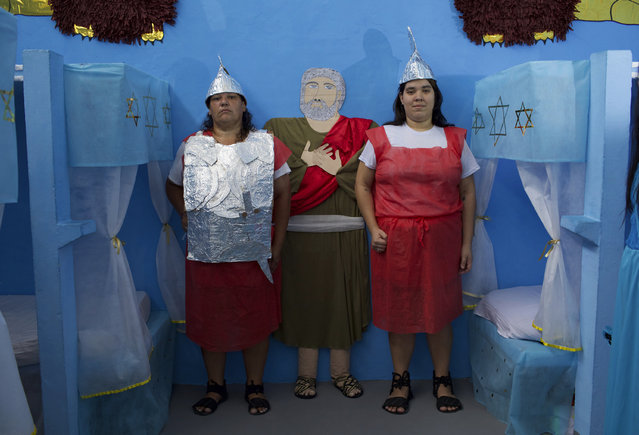 Female inmates dressed as guards pose for a photo during Nelson Hungria Prison's annual Christmas event for inmates and jail staff in Rio de Janeiro, Brazil, Thursday, December 13, 2018. Inmates serving time for offenses from burglary to homicide spent weeks decking out their cell blocks with handmade Christmas decorations and planning Bible related performances. (Photo by Silvia Izquierdo/AP Photo)
