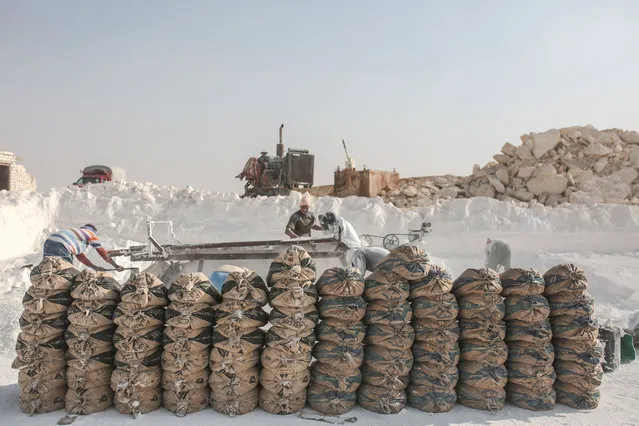 In this Wednesday, March 18, 2015 photo, bags filled with limestone powder are arranged for transport at quarry in the desert of Minya, Egypt. (Photo by Mosa'ab Elshamy/AP Photo)