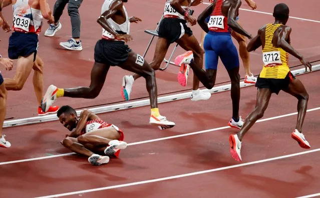 Bahrain's Dawit Fikadu falls during the men's 5000m heats during the Tokyo 2020 Olympic Games at the Olympic Stadium in Tokyo on August 3, 2021. (Photo by Phil Noble/Reuters)