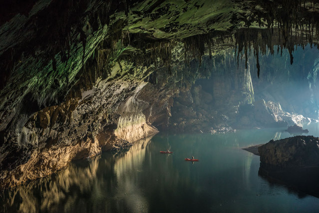Floating on clear deep water and reflections near the cave entrance. Visitors can either bring their own kayaks or rent boats from the local community to paddle deep inside the cave and marvel at its wonders on March 2015 at Tham Khoun Ex, Laos. Tham Khoun Xe, commonly known as the Xe Bang Fai River Cave, in Laos, has over 15km of passages filled with awe-inspiring views and wide expanses of water. (Photo by John Spies/Barcroft Media/ABACAPress)