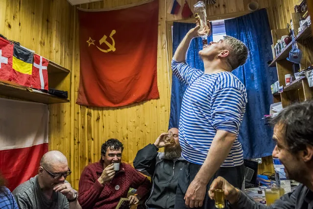 “An Antarctic Advantage”. Daily Life, first prize stories. Daniel Berehulak, Australia, The New York Times. Location: Antarctica. The winter expedition crew of Russian research team and a Chilean scientist drink Samagon, a homemade vodka, in a bedroom of the Bellingshausen Antarctica base. Chilean, Chinese and Russian research teams in Antartica seek to explore commercial opportunities that will arise once the treaties protecting the continent for scientific purposes expire. (Photo by Daniel Berehulak/World Press Photo Contest)