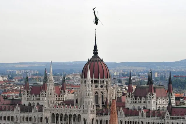 The Hungarian Air Force’s AS 350 helicopter flies low during the St. Stephen's Day celebration in Budapest, Hungary, August 20, 2021. (Photo by Marton Monus/Reuters)