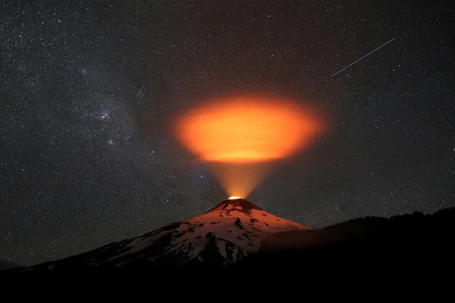 The Villarrica volcano lights up the sky at night seen from Pucon town, Chile on December 14, 2023. (Photo by Cristobal Saavedra Escobar/Reuters)
