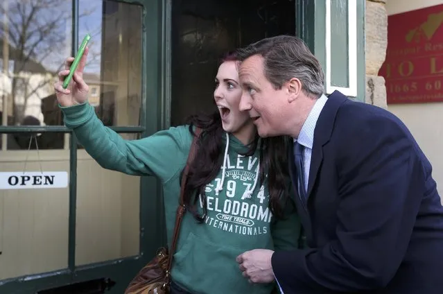 Britain's Prime Minister David Cameron poses for a selfie with a local woman as he campaigns in Alnwick,  April 13, 2015. (Photo by Peter Macdiarmird/Reuters)