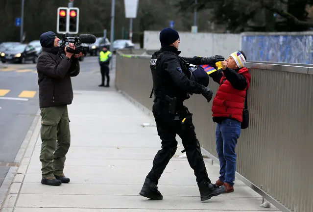 Protesters are detained by police as they take part in an unauthorised demonstration against Chinese President Xi Jinping outside the European headquarters of the United Nations in Geneva, Switzerland, January 18, 2017. (Photo by Pierre Albouy/Reuters)