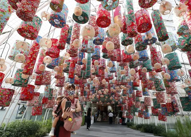 A foreigner with her baby takes a selfie with Chinese Lunar New Year decorations at a mall in Bangkok, Thailand, 08 February 2021. Thailand's economy is forecasted to grow at a slower pace than projected earlier by 1.5 to 3.5 per cent in 2021 after the sluggish local spending during Chinese Lunar New Year dropped to 21.85 percent, the lowest recorded in 13 years while the consumer price index plunged 0.34 percent year-on-year in January 2021 which is the 11th straight monthly fall. Thailand was one of Asia's worst hit economies by the ongoing COVID-19 coronavirus pandemic. (Photo by Rungroj Yongrit/EPA/EFE)