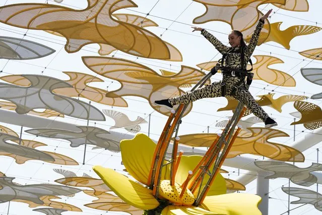 An acrobat performs at the Expo 2020 in Dubai, United Arab Emirates, Friday, October 1, 2021. After eight years of planning and billions of dollars in spending, the Middle East's first ever World Fair opened on Friday in Dubai, with hopes the months-long extravaganza draws both visitors and global attention to this desert-turned-dreamscape. (Photo by Jon Gambrell/AP Photo)