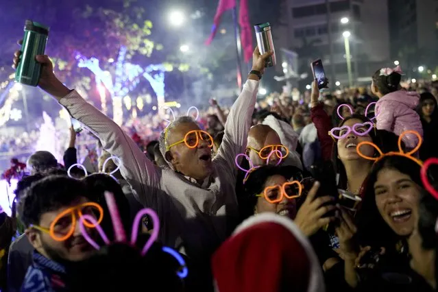 People celebrate New Year at Plaza Altamira in Caracas, Venezuela, early Monday, January 1, 2024. (Phoot by Matias Delacroix/AP Photo)